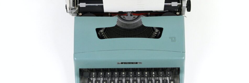 teal and black typewriter machine